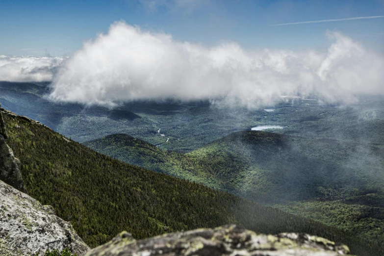 white clouds above the green hills and mountains