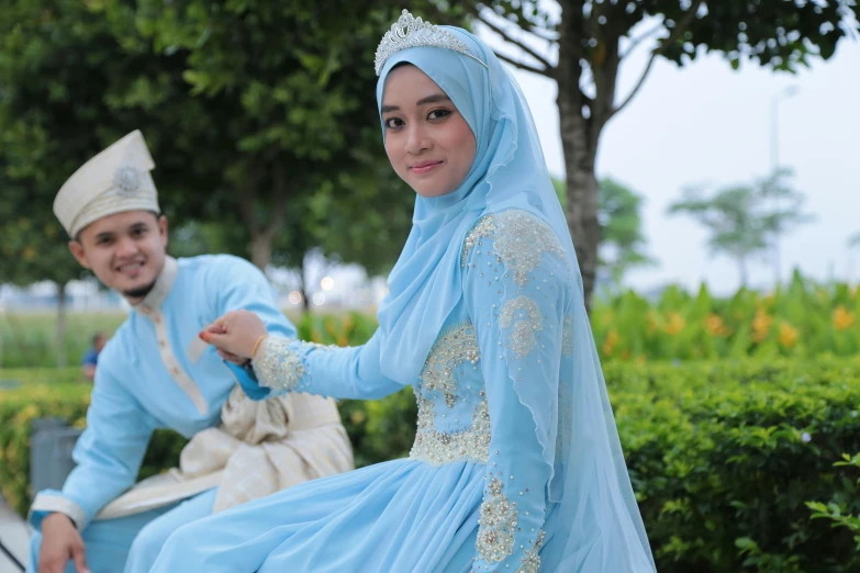 an attractive couple is dressed up to pose for a po