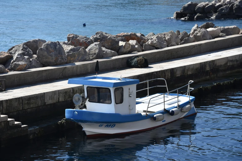 a small boat tied up to a dock