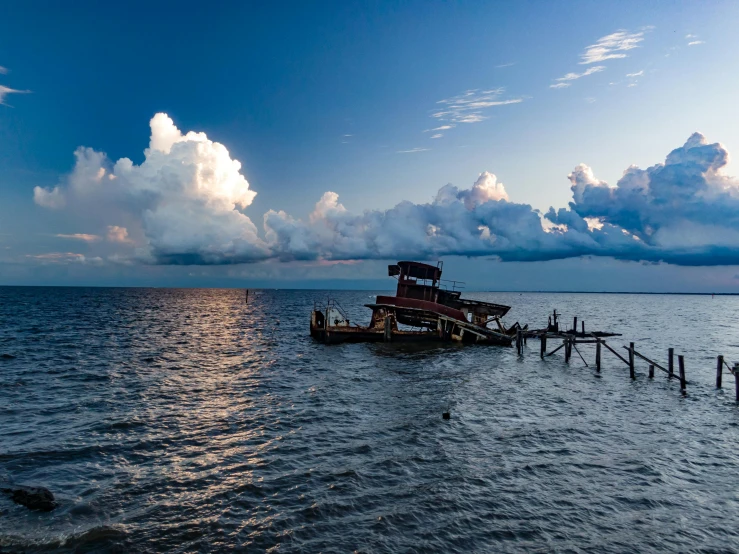 the ocean and pier have clouds in it