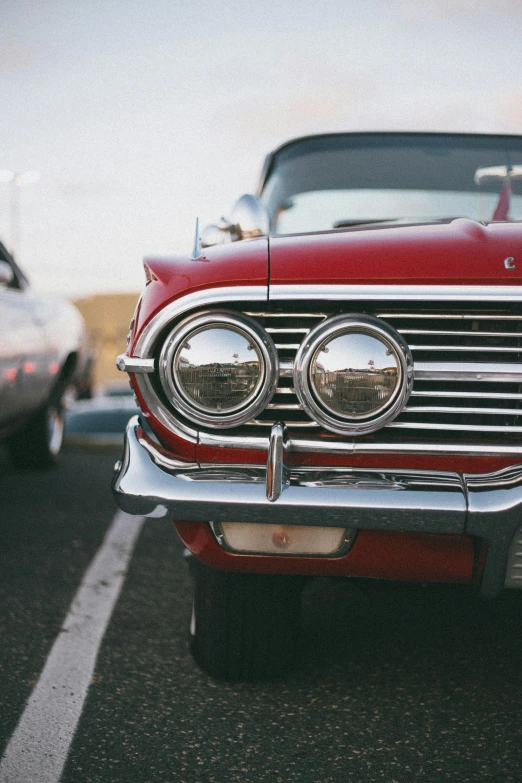 two old fashioned cars in parking lot