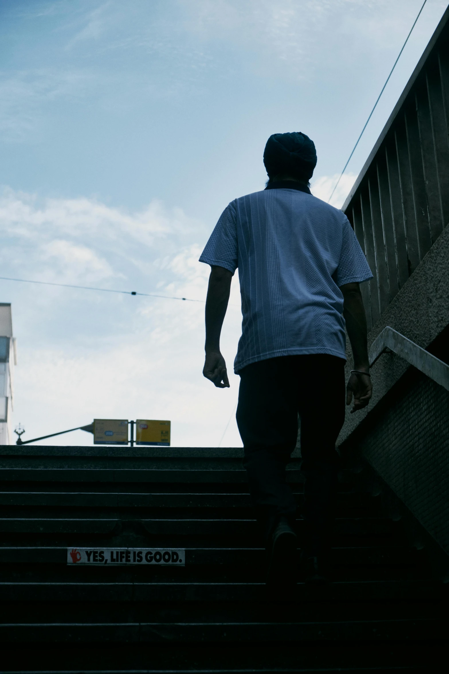 a man walking down some stairs while talking on his phone