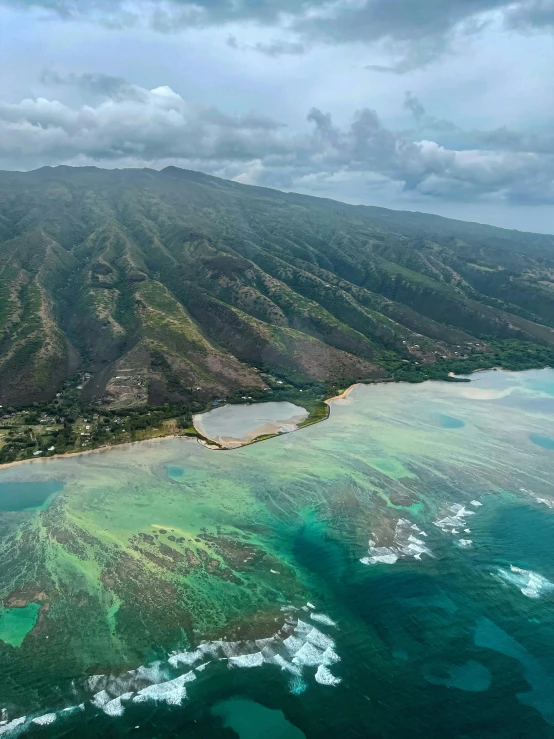 an aerial view of a beautiful green beach