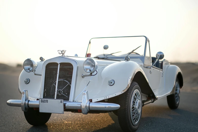 the front of an old fashioned white vehicle