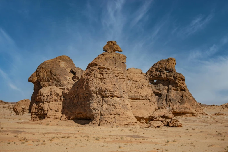 several large rock formations sit in the middle of a desert