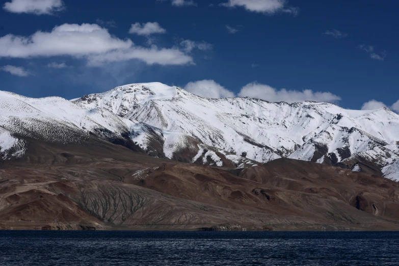 snow covered mountains in the desert on the ocean