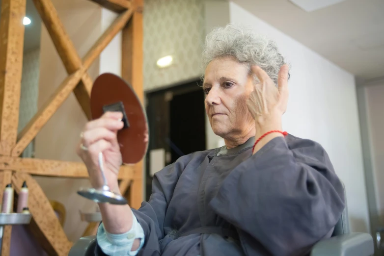 a lady that is holding a device in one hand