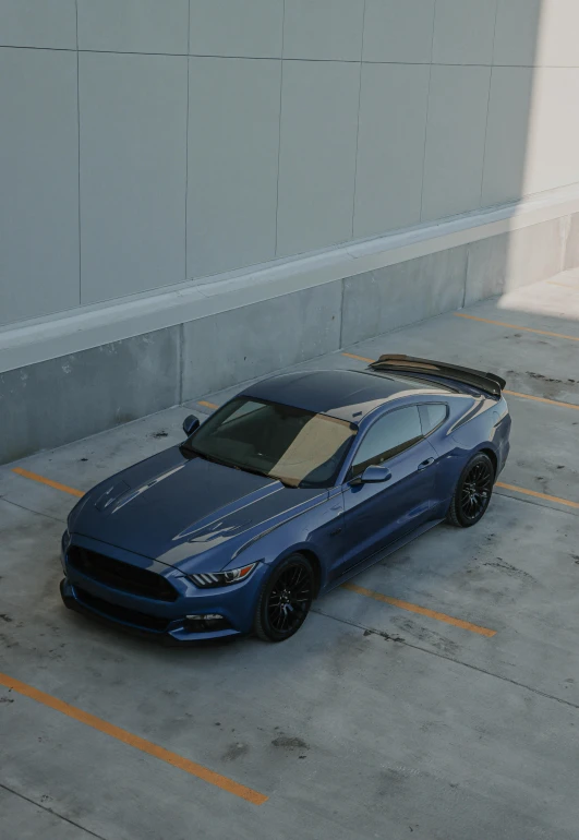 a blue sports car is parked in the parking lot