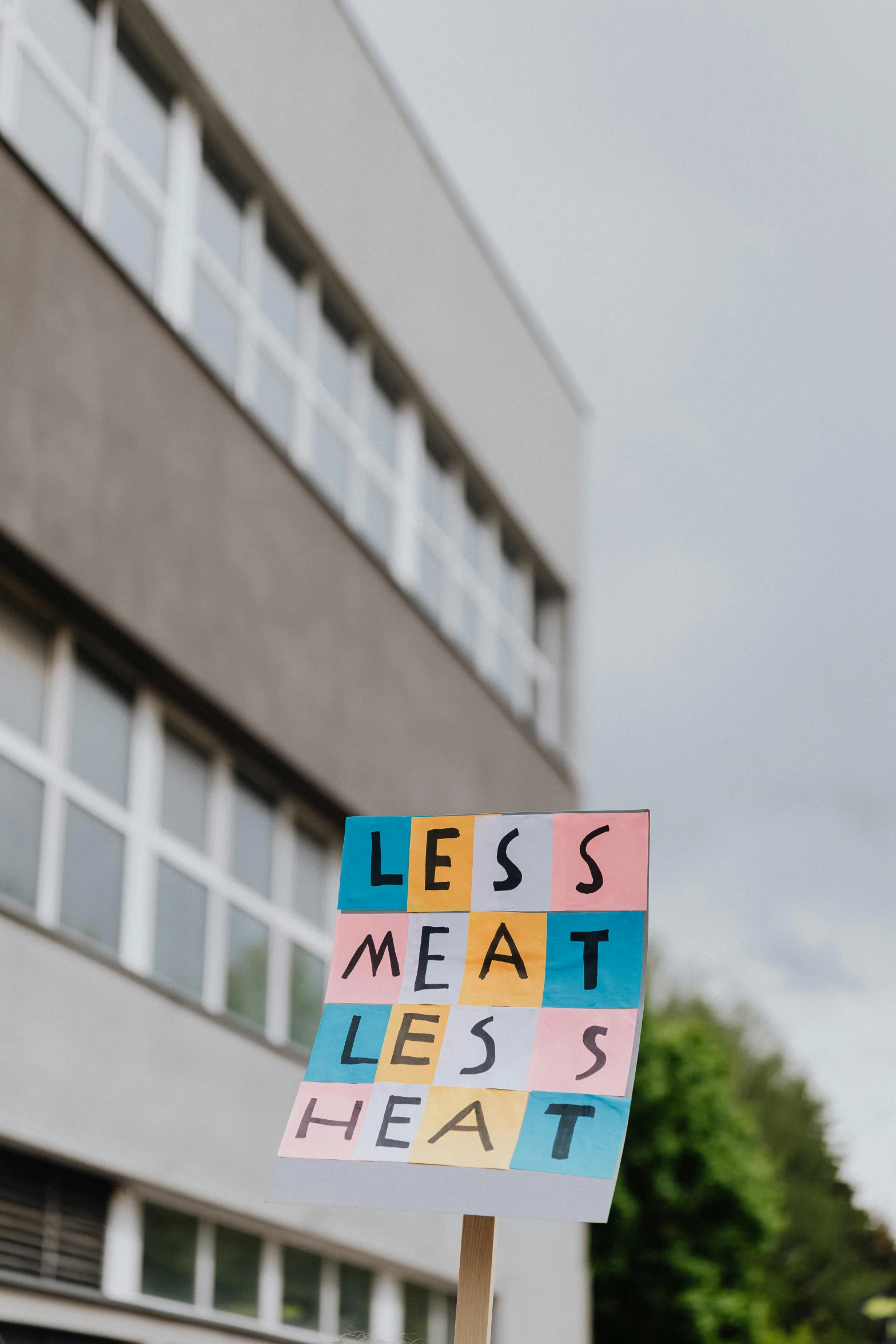 a person holding up a sign near a building