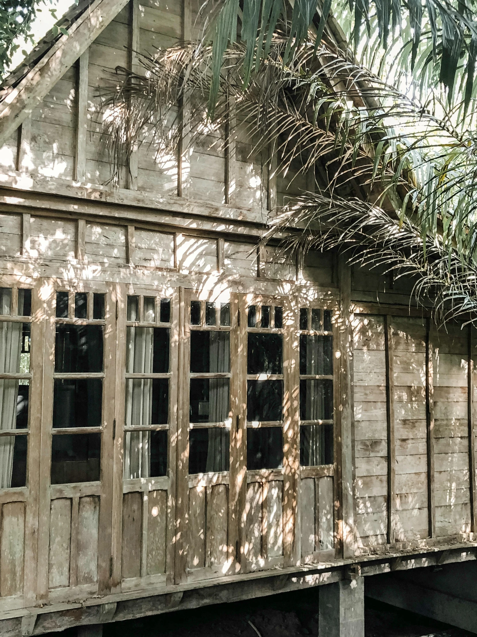 a house made of wood with wooden windows