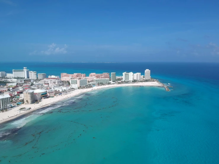 aerial view of a white beach in the blue ocean