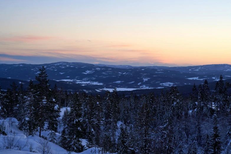 there are mountains in the background at sunset