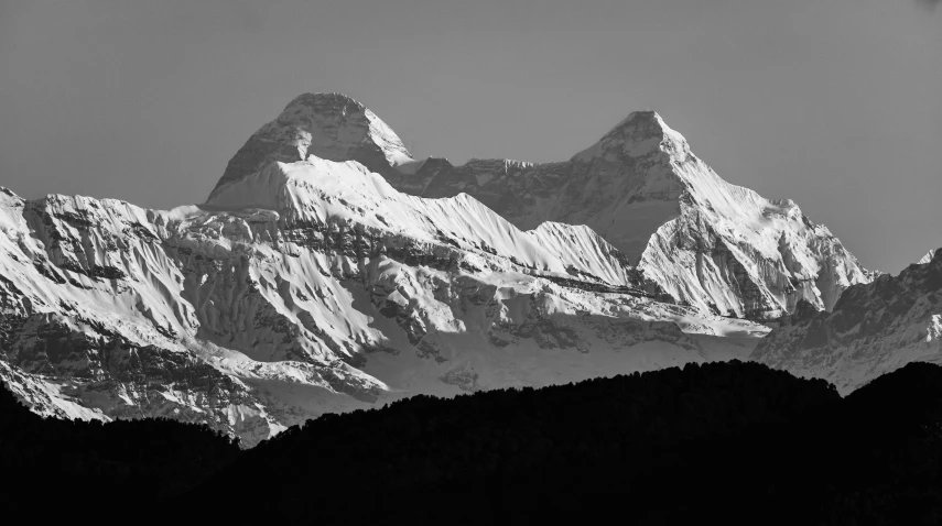 a large mountain that is in the middle of a forest