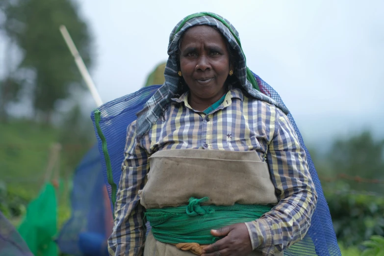 woman wearing an apron and plaid shirt