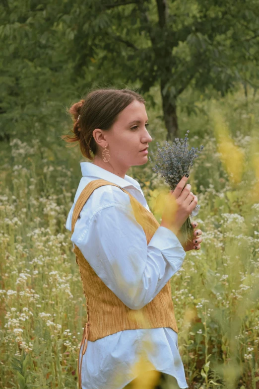 a young woman standing in a field of wildflowers