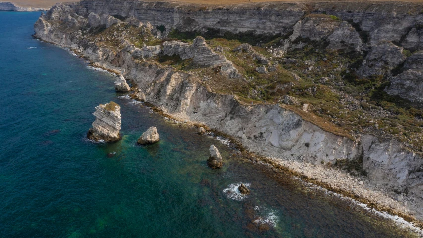 a small island that has two smaller cliffs near it