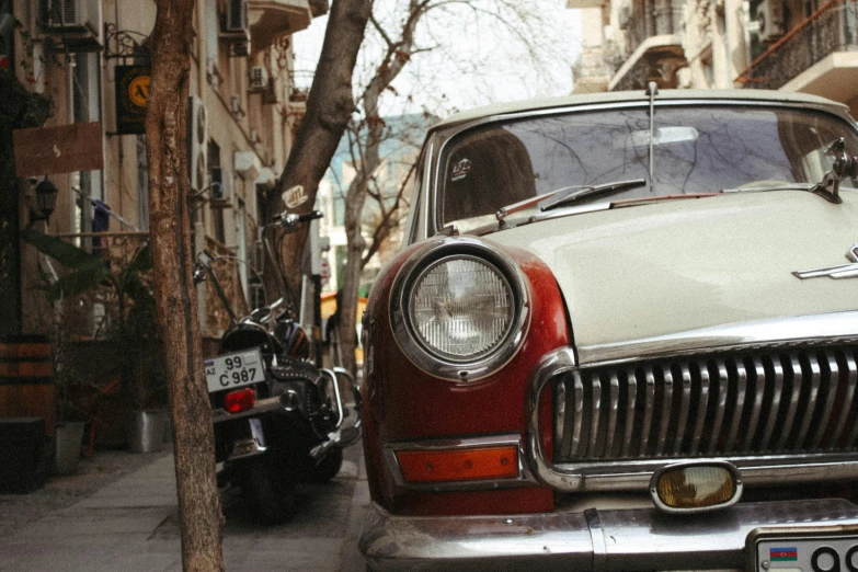 a red and white car parked on the street