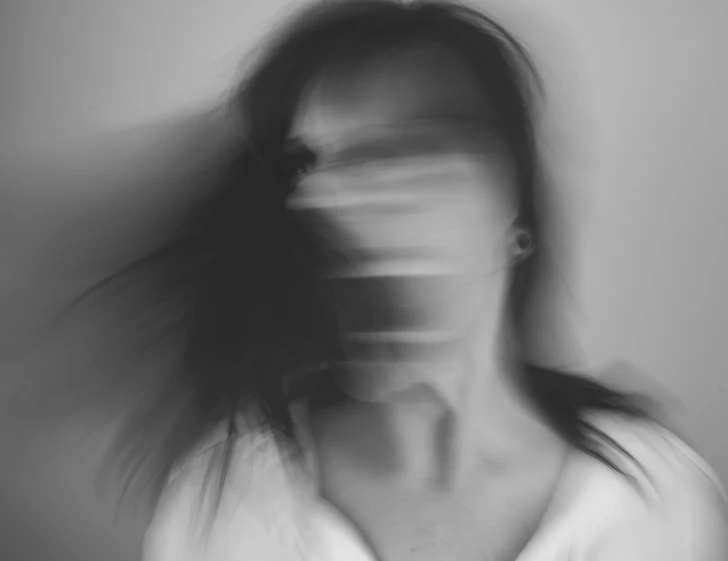 a person's face blurry with long hair
