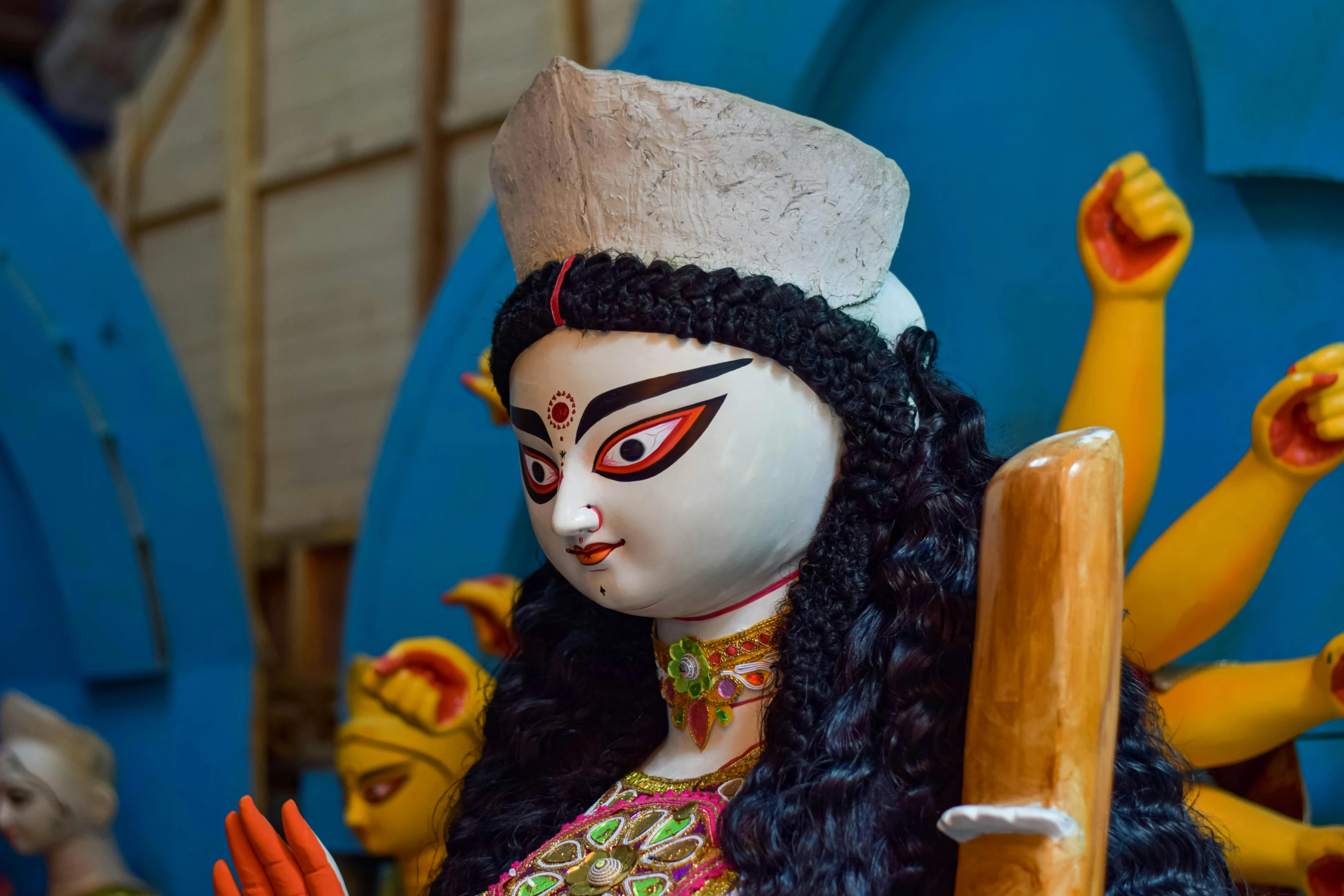 an indian doll with long hair and a headdress