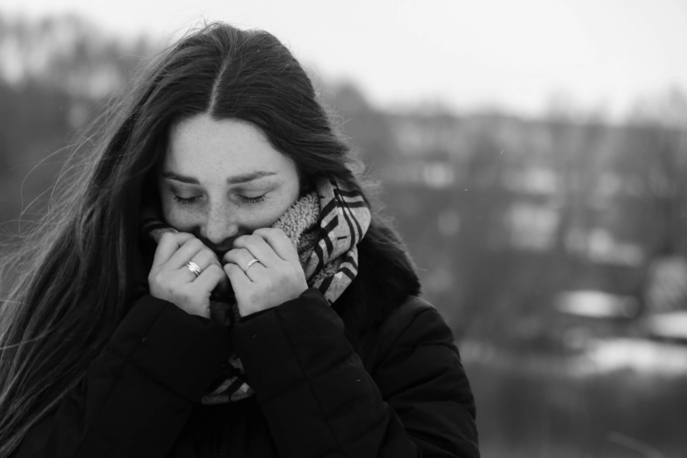 a woman is covering her face with her hands