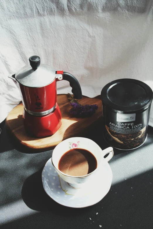 a small plate, cup and saucer with tea and food