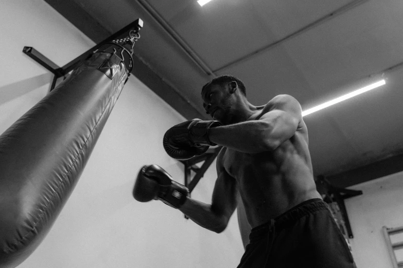 man in boxing gloves standing in a punching bag