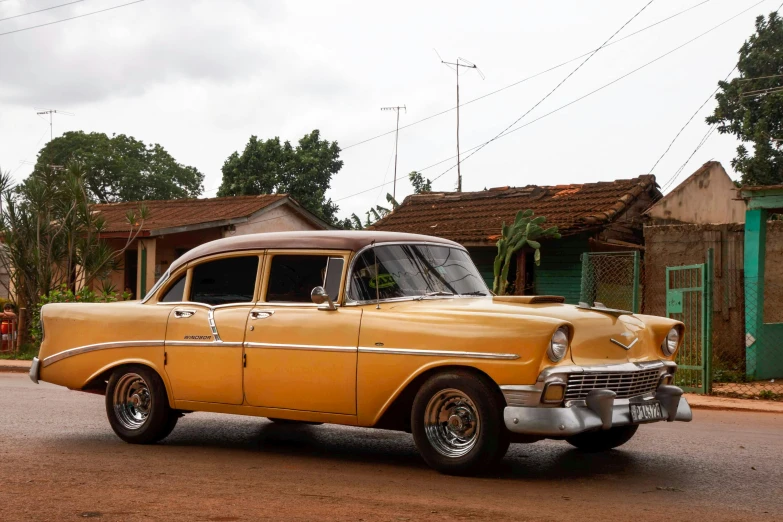 an old car parked on the side of a road