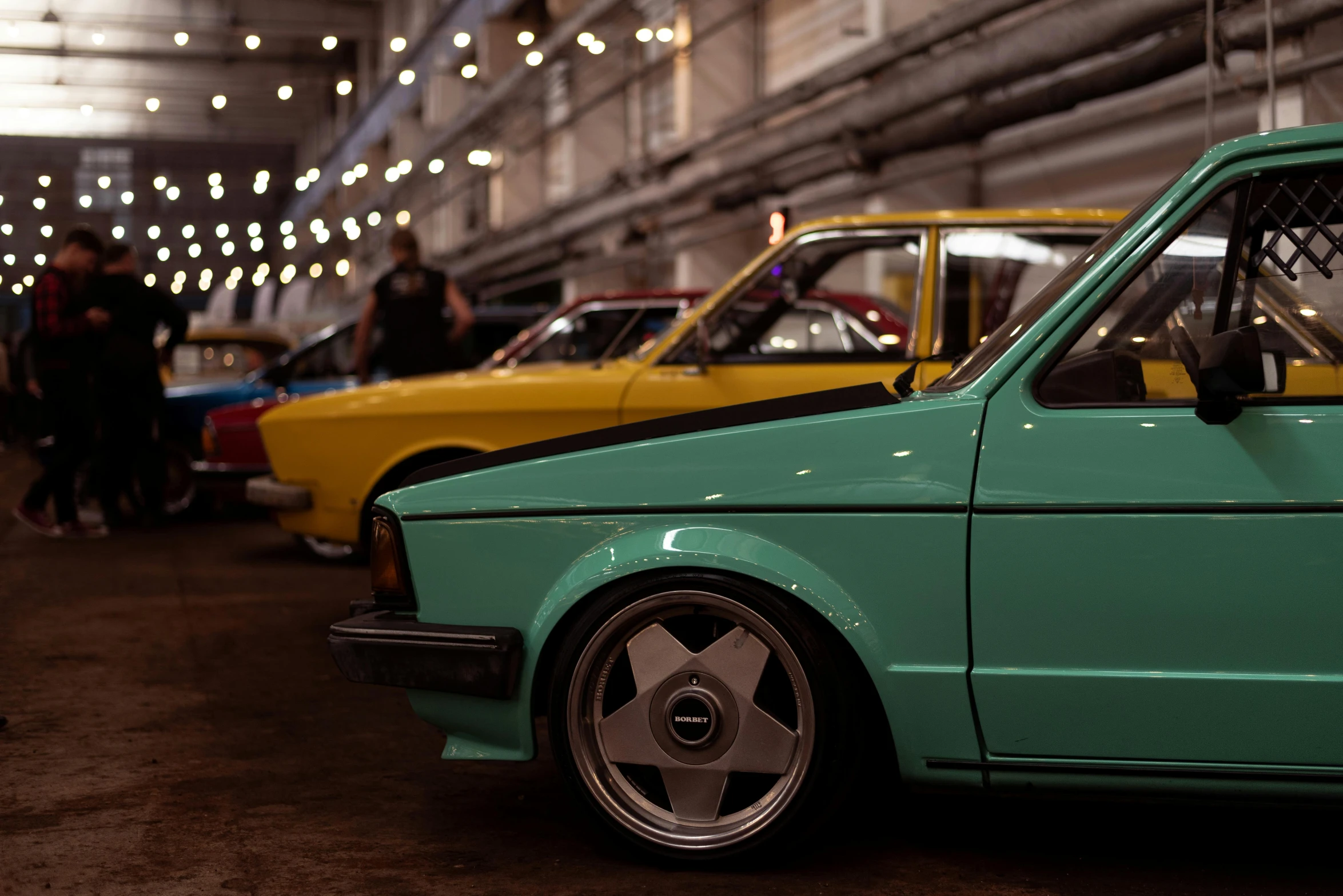 a group of cars that are parked in a garage