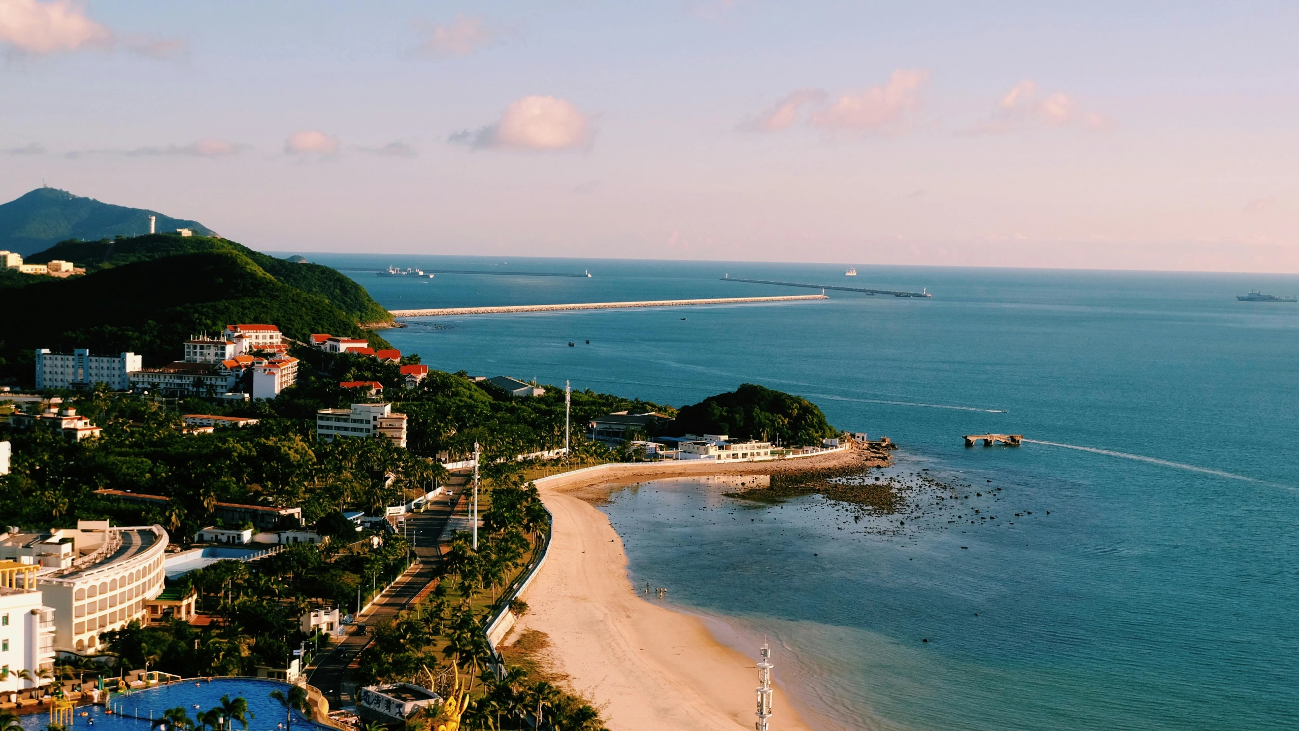 a city by the water and another beach with a lot of people