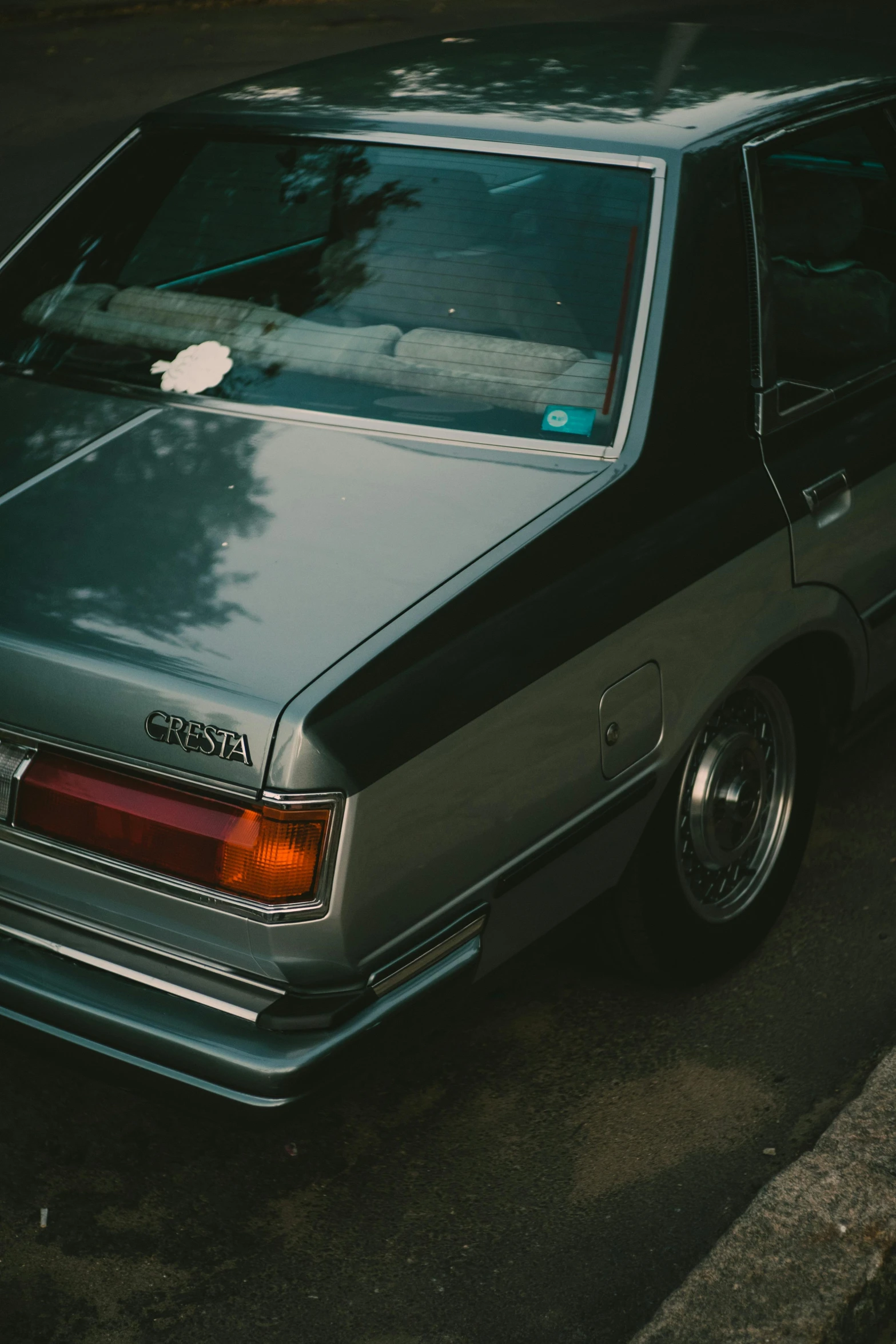 an older automobile parked on the side of a road