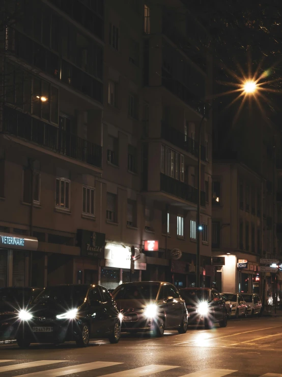 some cars lights people buildings and buildings at night