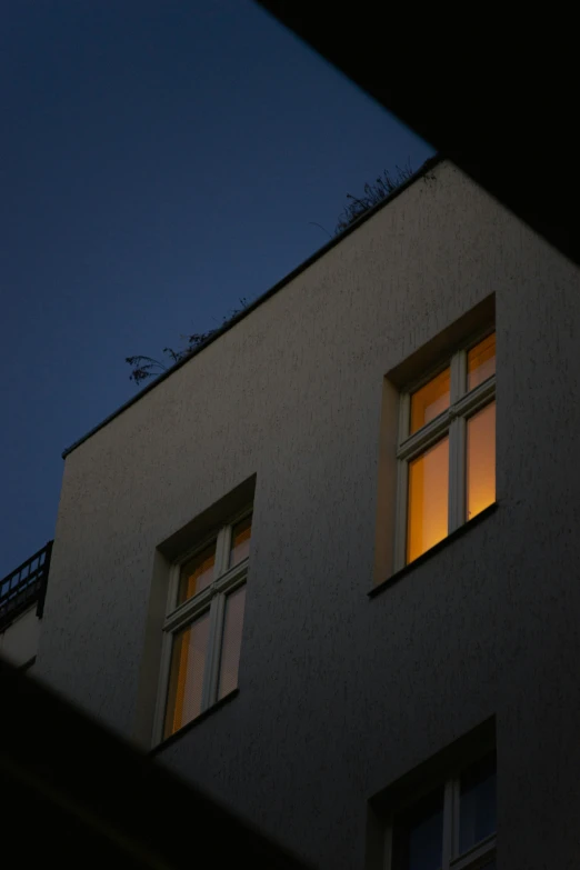 lit window on dark wall at night time