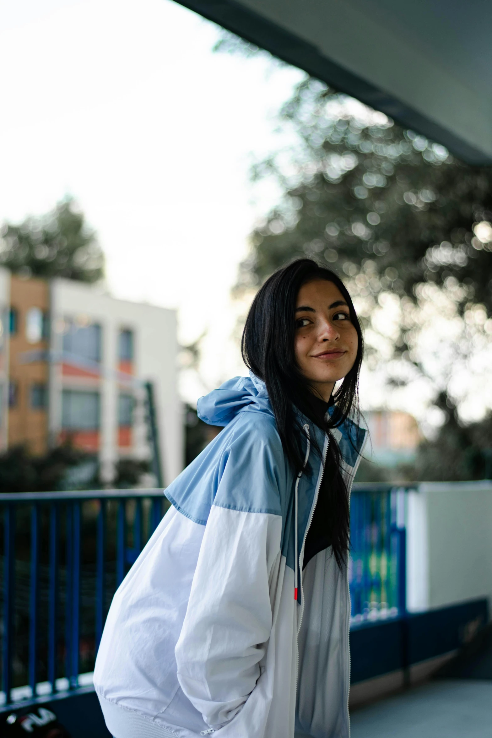 a girl with a hoodie smiling at the camera