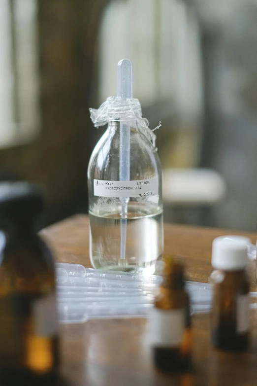 a table topped with bottles and empty glass jars