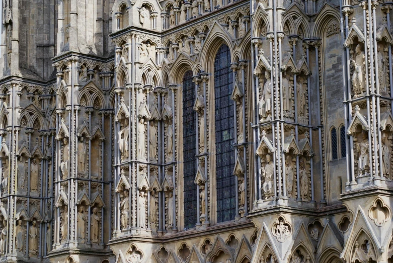 the tall church has several ornate arches on it