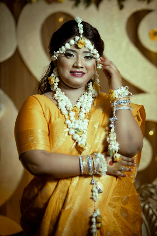 a woman wearing a yellow outfit and white jewelry