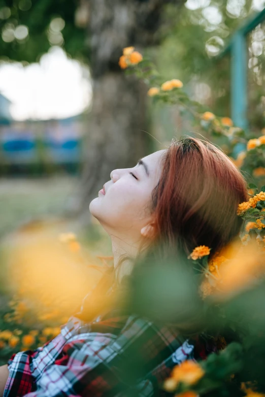 a young woman lays in the flowers