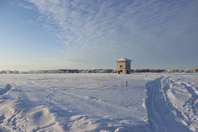 a clock tower in the middle of a field