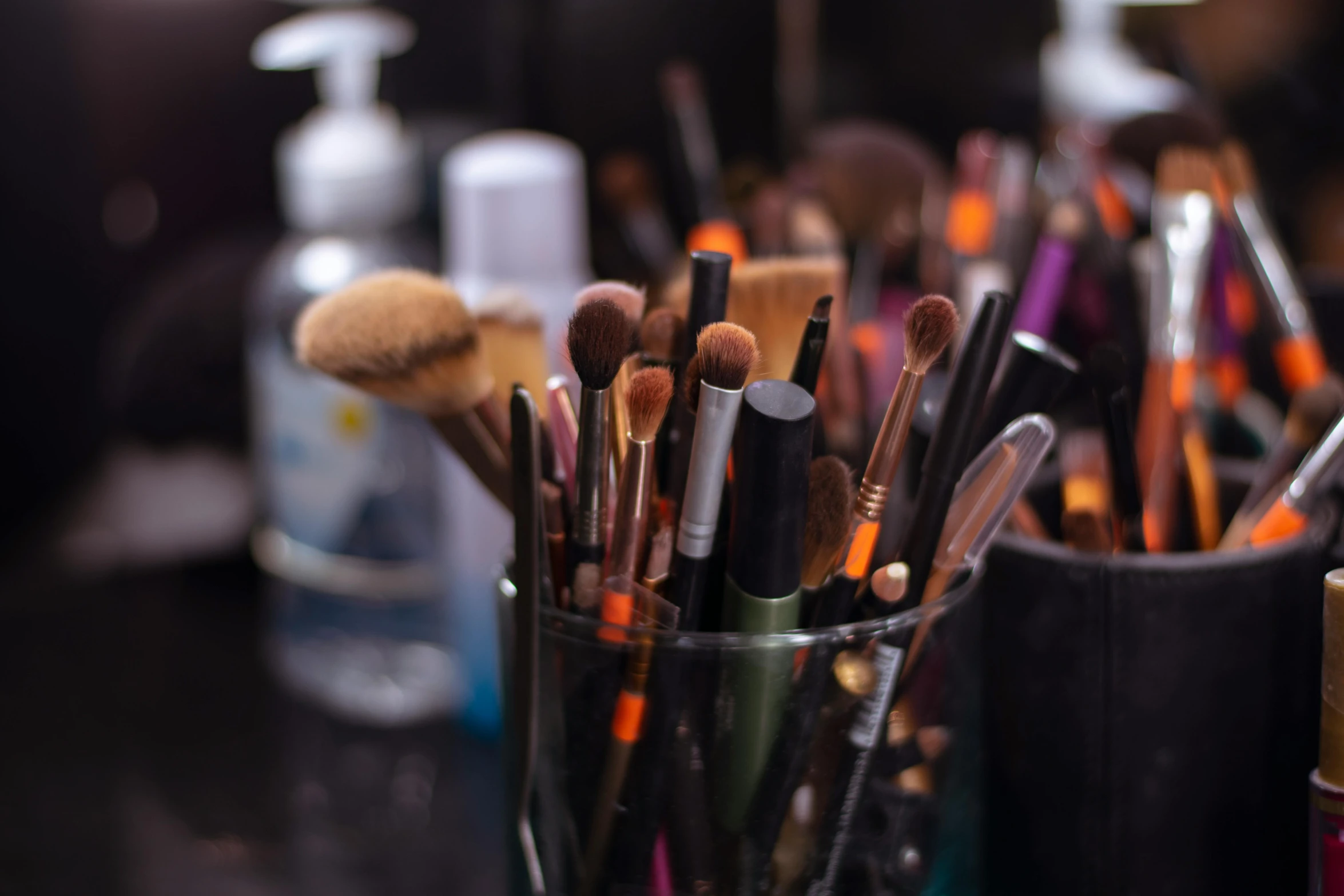 a bunch of brushes sitting inside of a cup