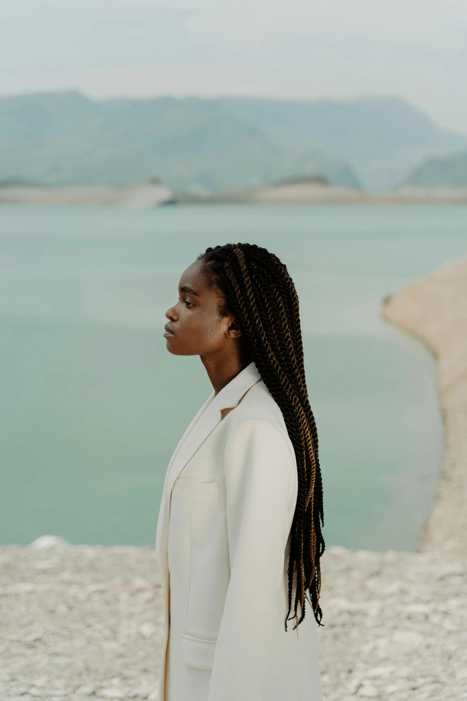 a young woman standing on top of a beach