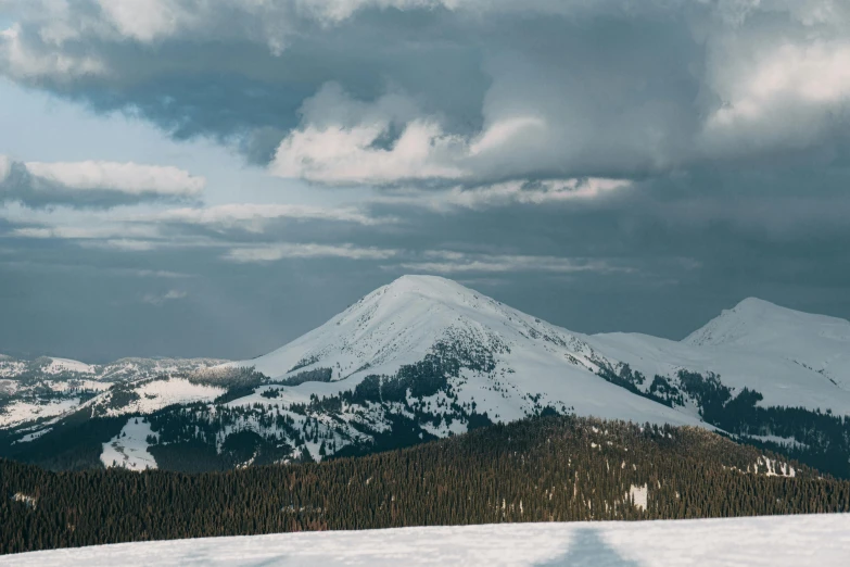 a person on skis standing on the top of a mountain