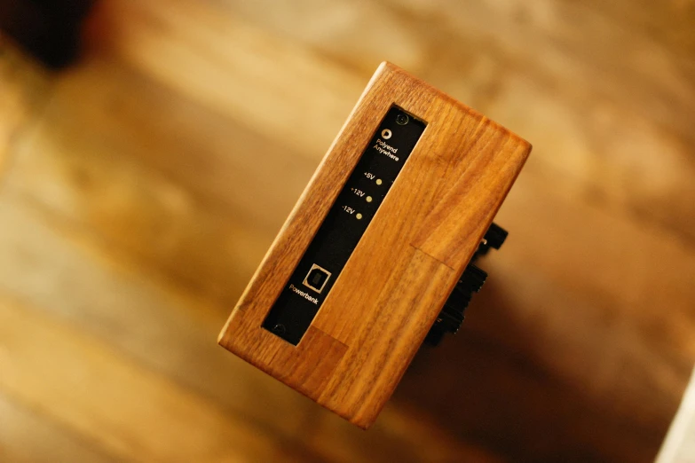 a wooden clock on the arm of a man