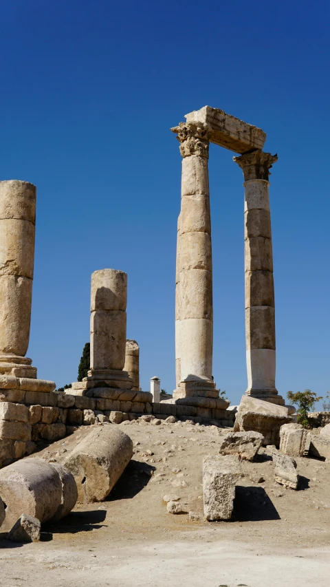 two large stone columns sit in the desert