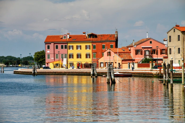 houses sitting along the water in front of buildings