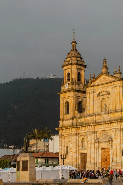 an old church building with lots of people around