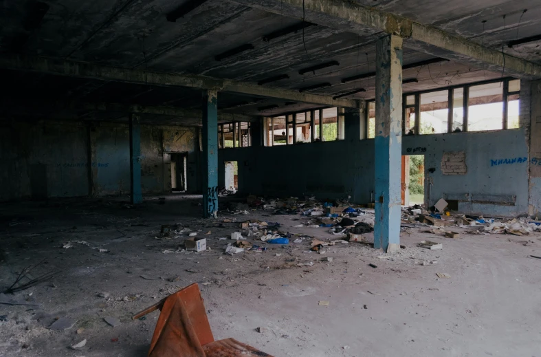 there is trash strewn on the floor of this old building