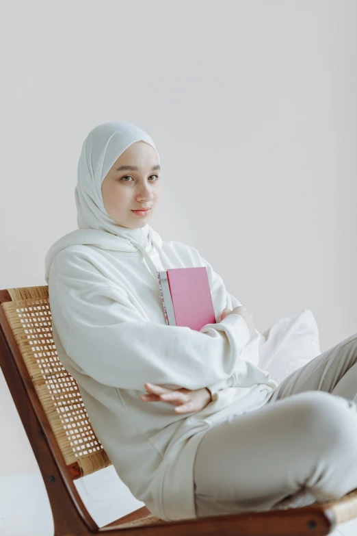 a woman in a white robe and white shoes