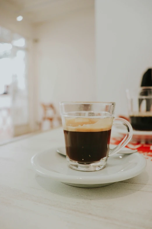 a glass on a plate in front of a counter