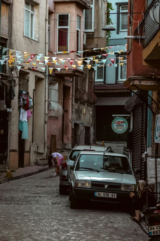 several cars parked in an alleyway next to buildings