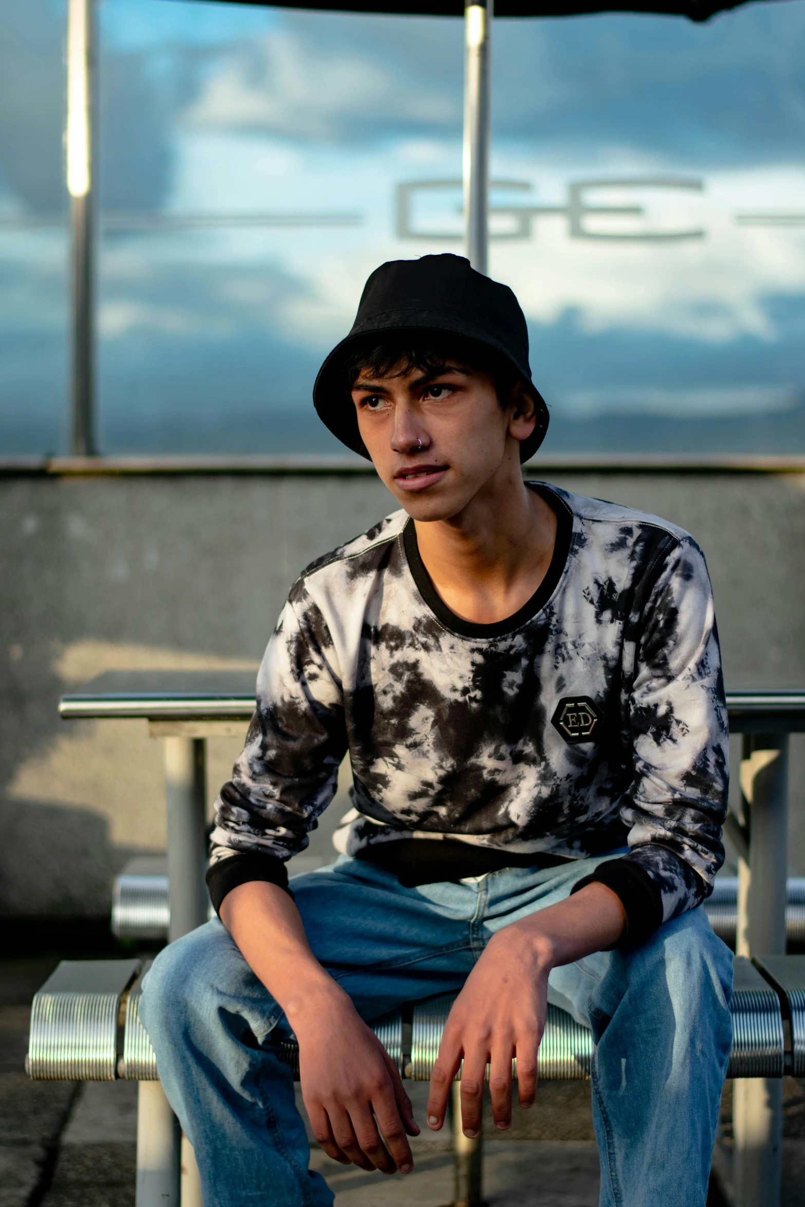 a young man is sitting on a bench